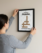 Christmas family crossword framed poster being hung