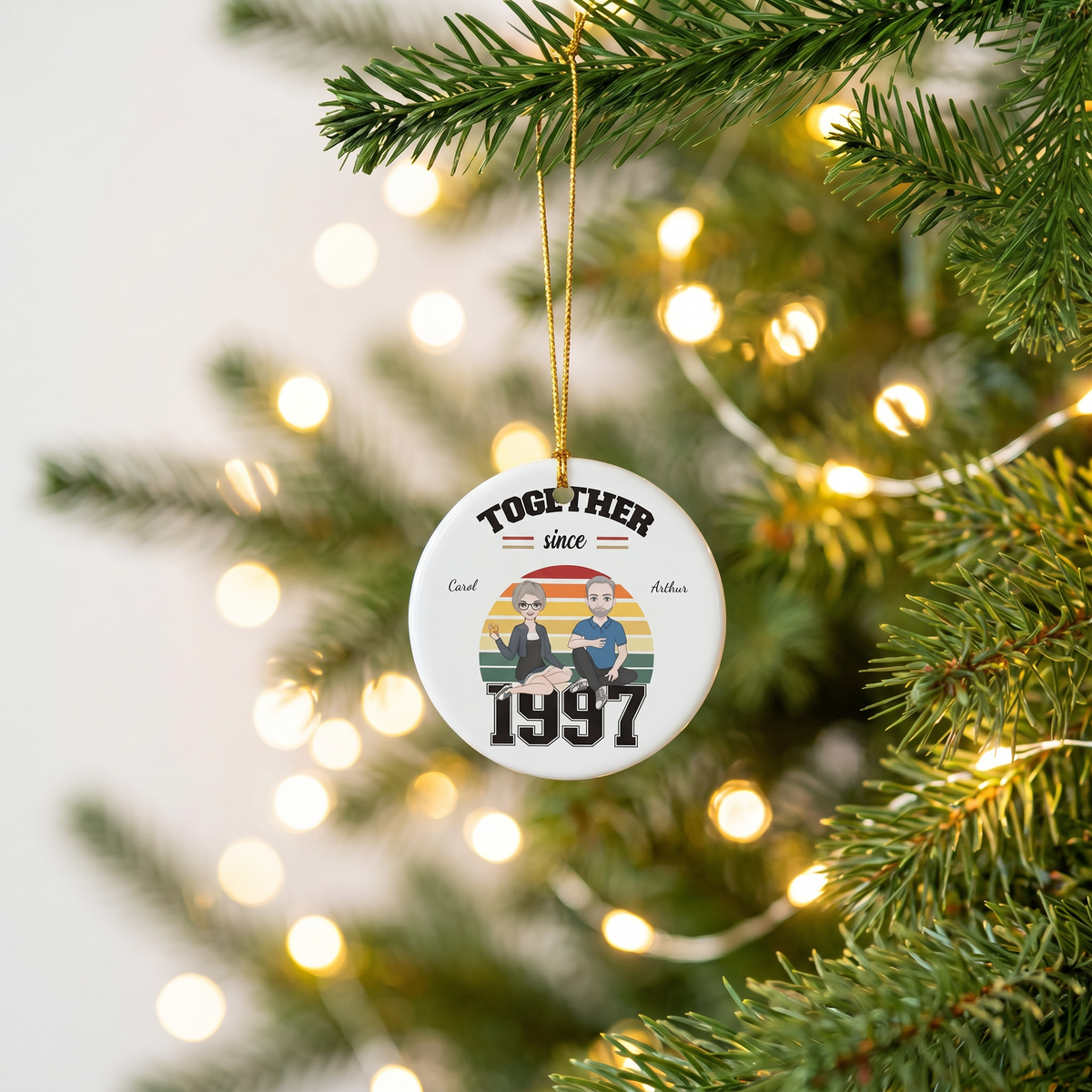 Personalized Together Since couples ceramic Christmas ornament hanging on a pine branch with warm holiday lights