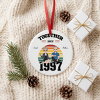Together Since anniversary ceramic Christmas ornament on a cream knit blanket with pine and a gift