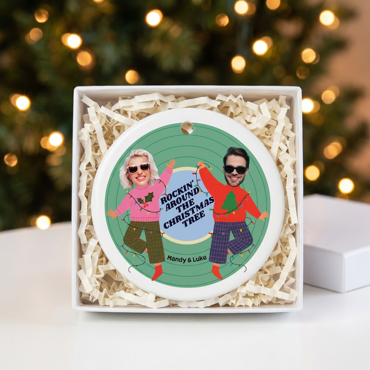 Custom face photo ceramic Christmas ornament in an open white gift box with shredded paper