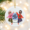 Custom face cut photo ceramic Christmas ornament hanging on a pine branch with warm holiday lights