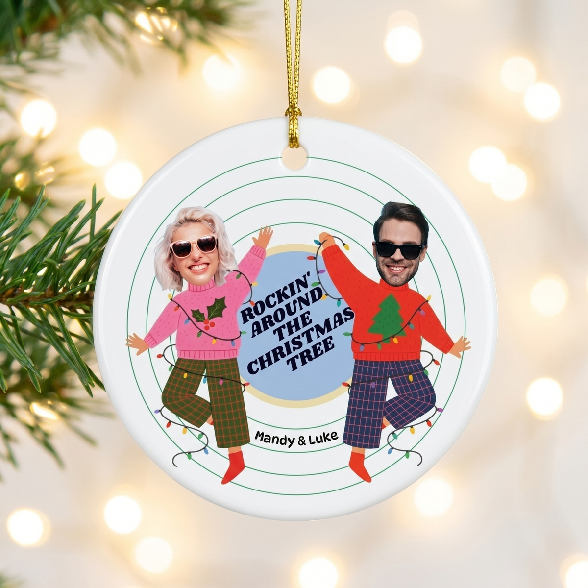 Custom face cut photo ceramic Christmas ornament hanging on a pine branch with warm holiday lights