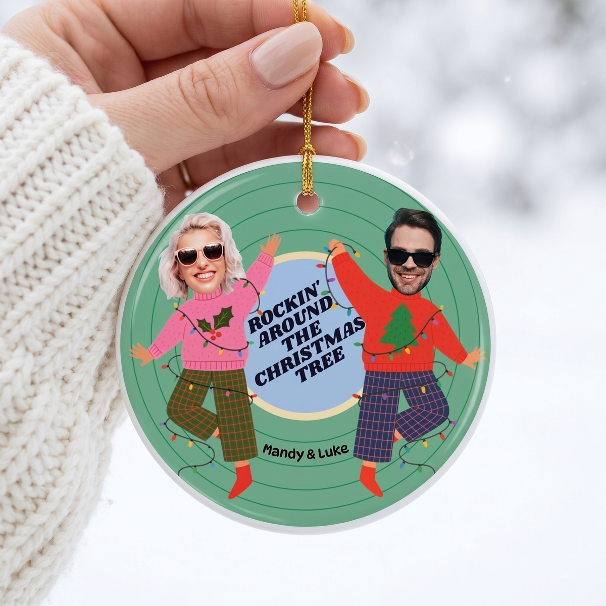 Hand holding a custom face cut photo ceramic Christmas ornament in a white knit sweater