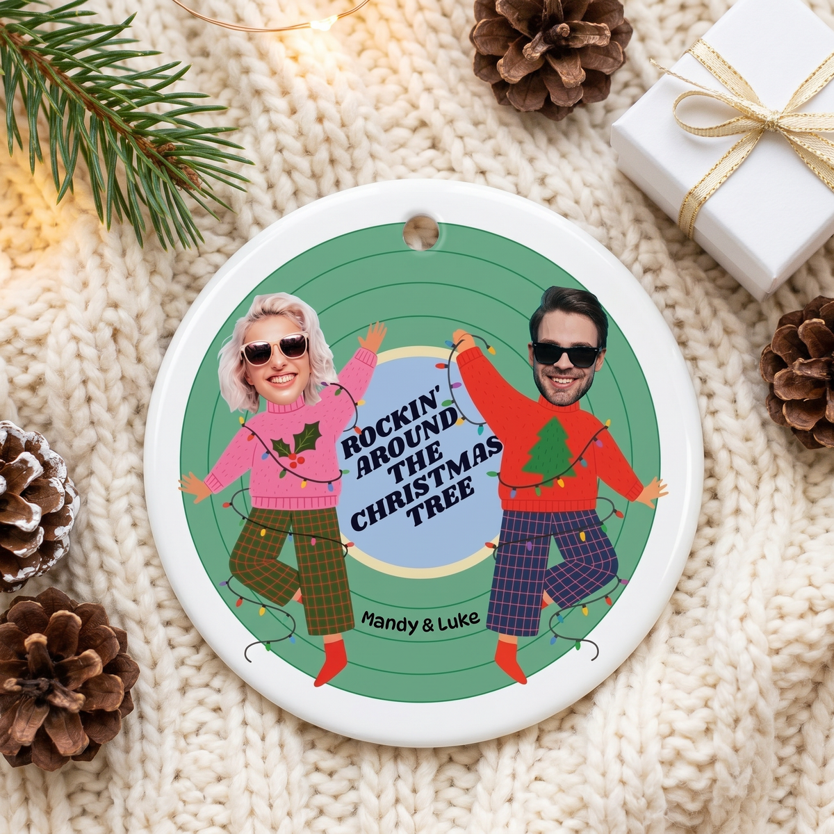 Personalized photo ceramic Christmas ornament on a cream knit blanket with pine and a gift