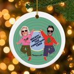 Custom photo ceramic Christmas ornament hanging on a pine branch with golden Christmas lights