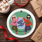 Personalized photo ceramic Christmas ornament on a rustic wood table with cocoa
