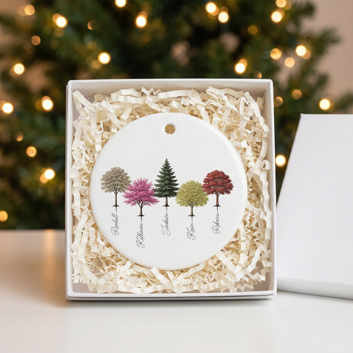 Custom My Forest ceramic Christmas ornament in an open white gift box with shredded paper