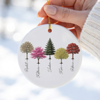 Hand holding a custom My Forest woodland ceramic Christmas ornament in a white knit sweater