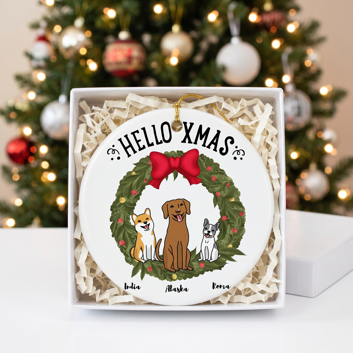 Personalized dog Christmas ceramic ornament in an open white gift box with shredded paper