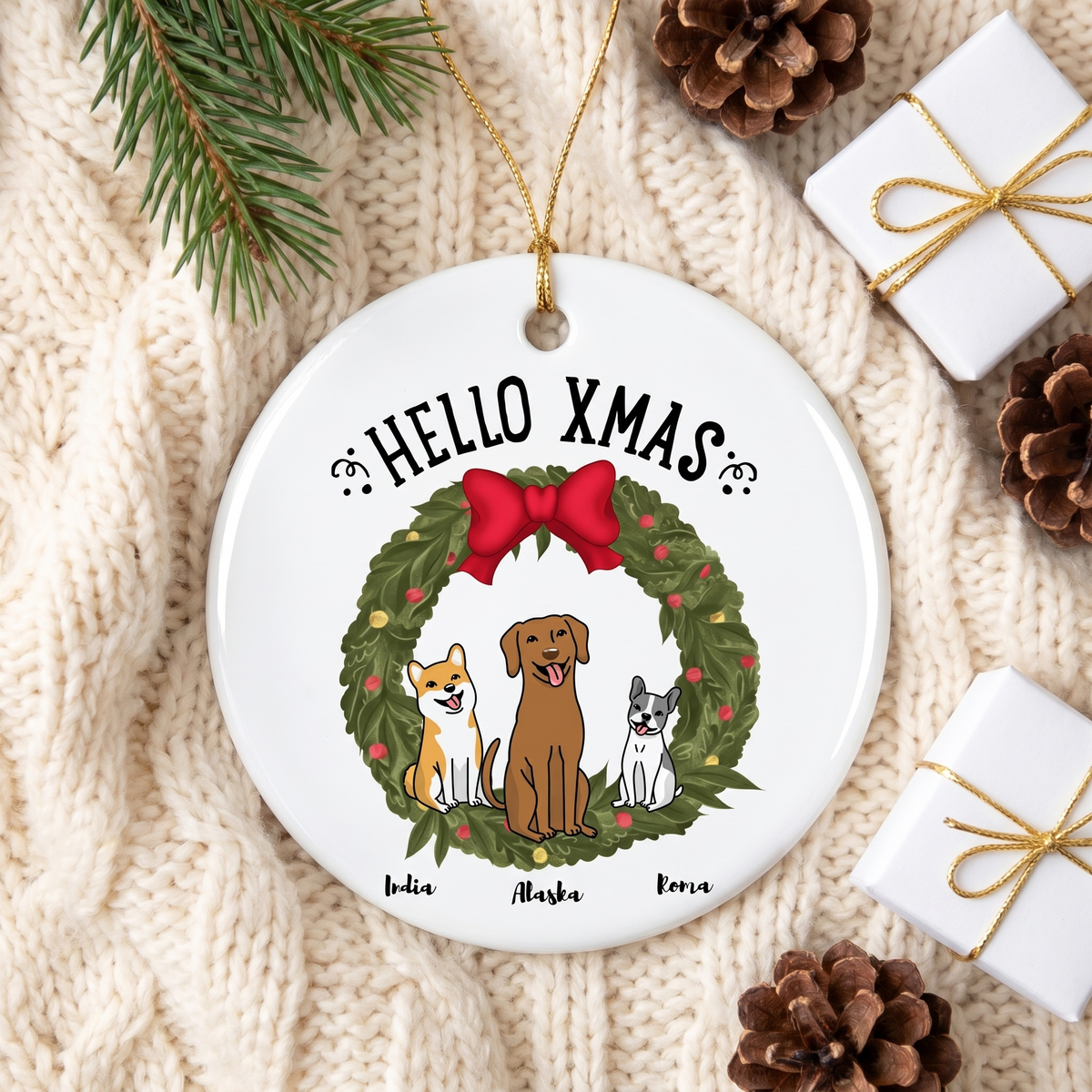 Personalized dog ceramic Christmas ornament on a cream knit blanket with pine and a gift