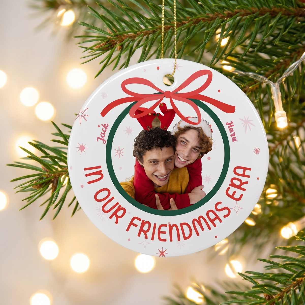 In Our Era personalized ceramic Christmas ornament hanging on a pine branch with holiday lights