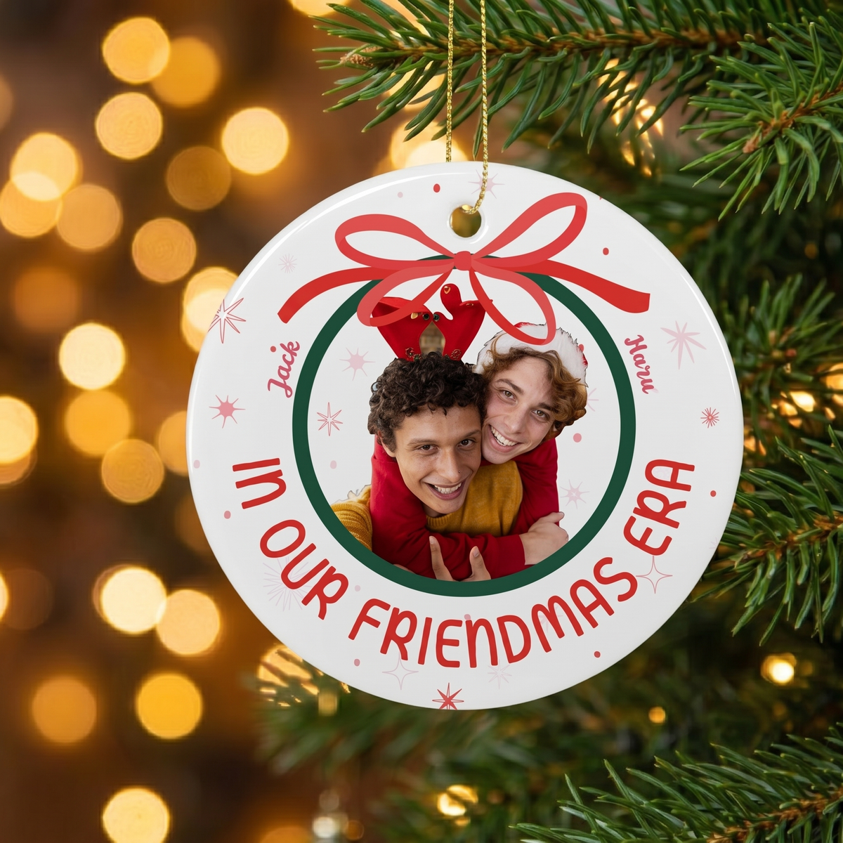 In Our Era ceramic Christmas ornament hanging on a pine branch with golden Christmas lights