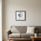 Custom street map framed poster in a black frame hanging above a living room sofa