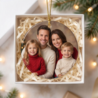 Personalized family photo ceramic Christmas ornament in an open white gift box with shredded paper filler