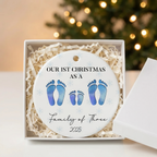 Family of four footprint ceramic Christmas ornament in an open white gift box with shredded paper