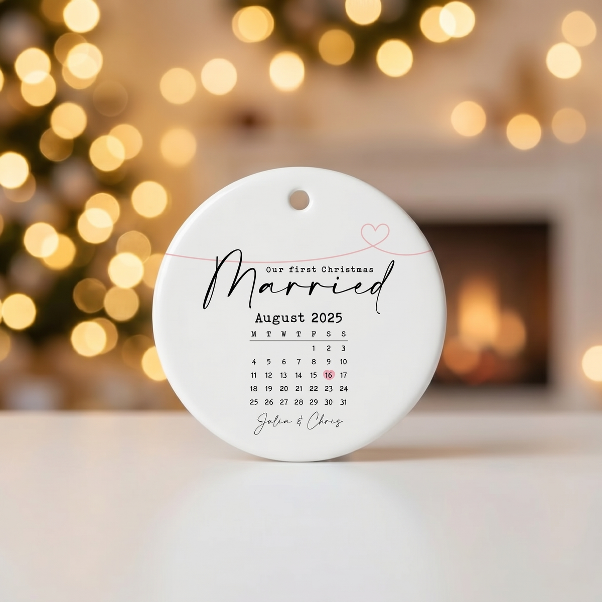 Personalized Married August 2025 calendar ceramic ornament against warm golden Christmas bokeh