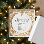 First Christmas Married calendar ceramic ornament in an open white gift box with shredded paper filler