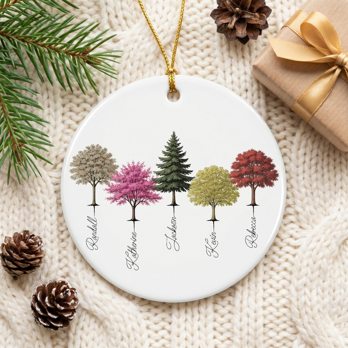 My Forest family tree ceramic ornament flat-lay on a cream knit blanket with pinecones