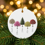 My Forest family tree ceramic ornament nestled in pine branches with golden Christmas lights
