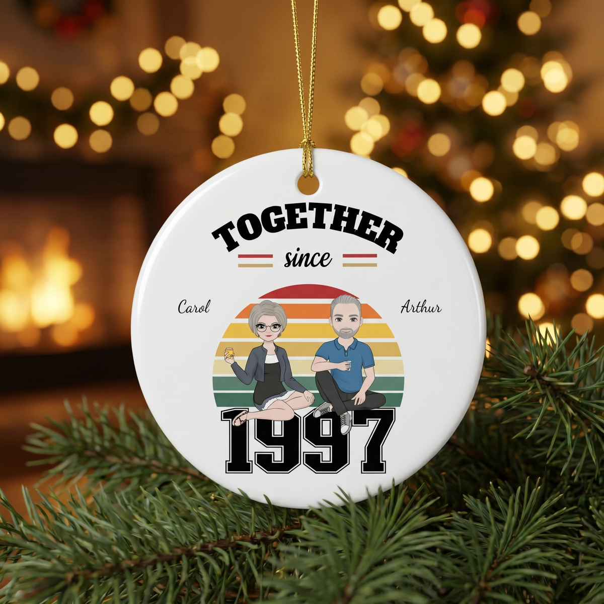 Together Since 1997 ceramic ornament nestled in pine branches with golden Christmas lights